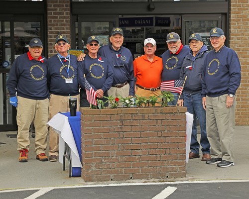 American Legion Post 370 members give away poppies and collect donations for the American Legion Child Welfare Fund at Bryson's Grocery in Highlands.